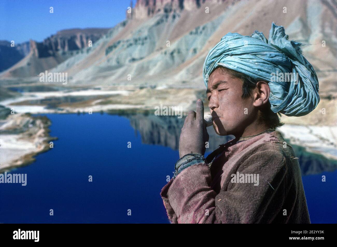 Boy playing clay flute Band e Amir Central Afghanistan Stock Photo