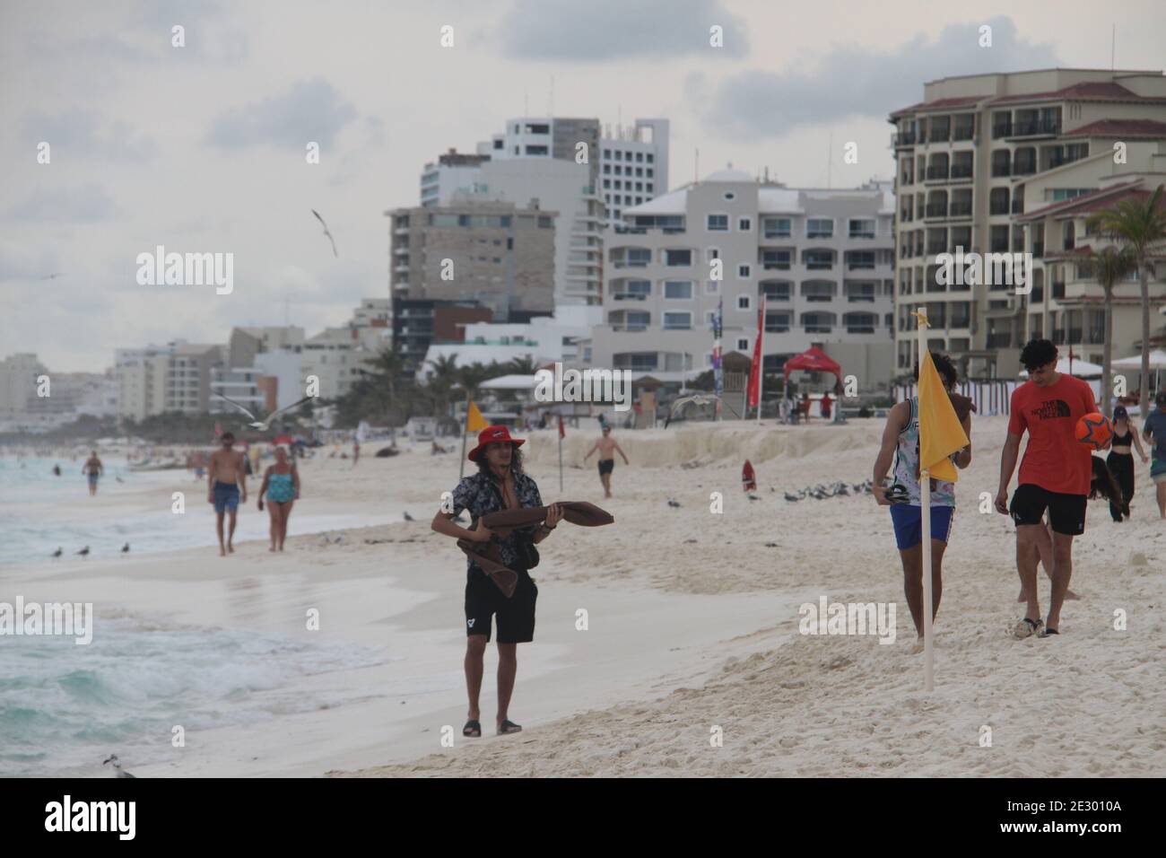 Imagem de pessoas jogando vôlei na praia.