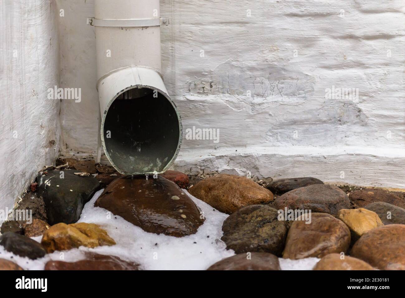 Storm water drain. Gutter from the roof. Water pours out of the gutter