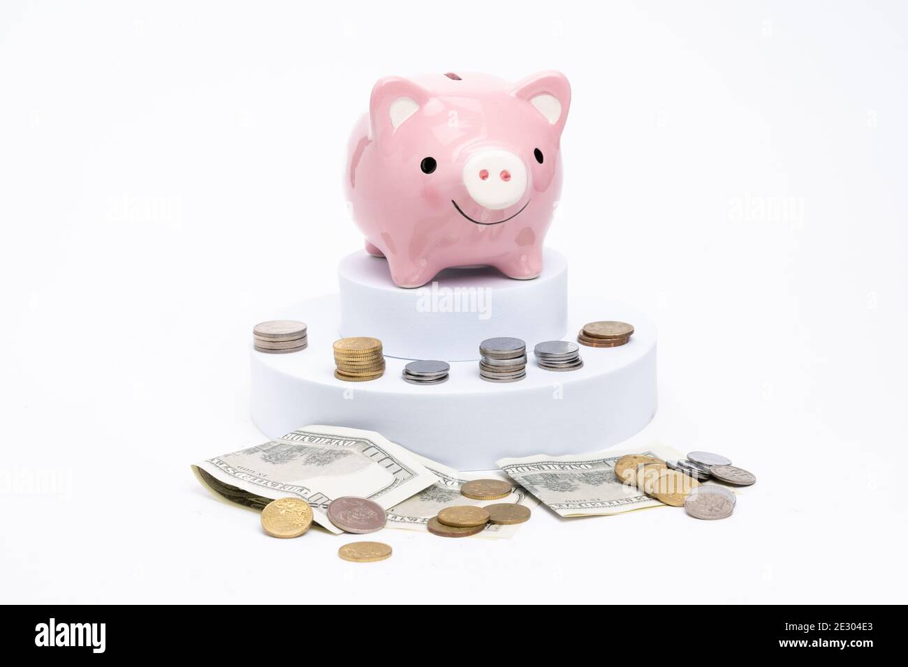 Piggy bank with scattered coins on white background Stock Photo - Alamy