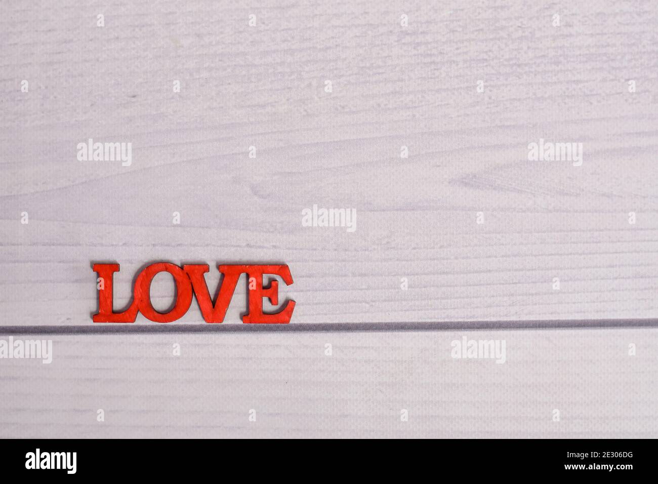 the inscription love on a wooden background. layout. Stock Photo
