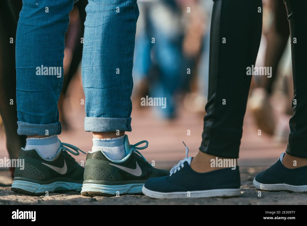 MOSCOW, RUSSIA-MAY 09, 2015: people are dancing outdoors in the Park on Pushkinskaya embankment at sunny day. nike sneakers on women's feet in the Stock Photo