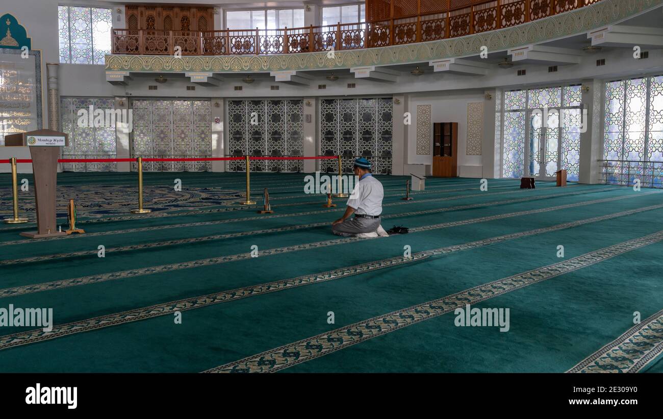Pavlodar, Kazakhstan - July 27, 2020: Lonely islamic prayer in the Mashkhur Jusup Mosque in Pavlodar, Kazakhstan. Stock Photo