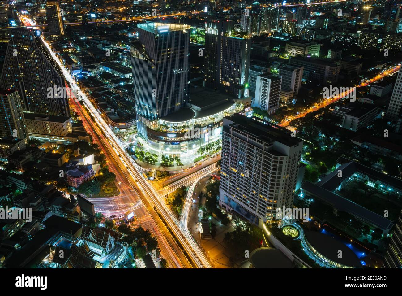 Bangkok business district city center above Samyan intersection and traffic, with buildings and skyscrapers, during night - Time Lapse Stock Photo