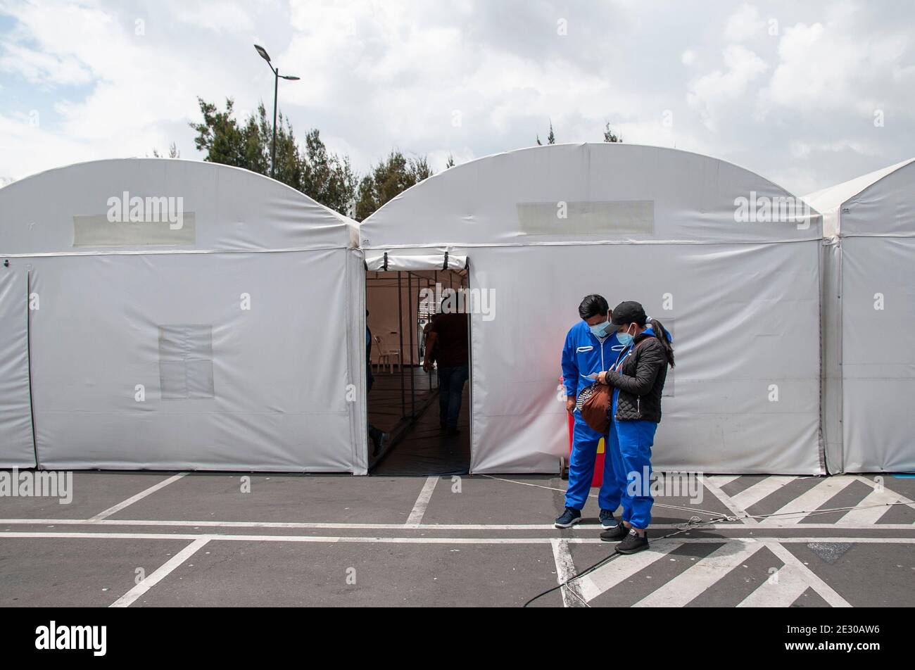 Quito, Ecuador. 15th Jan, 2021. Two patients check their PCR results outside the improvised