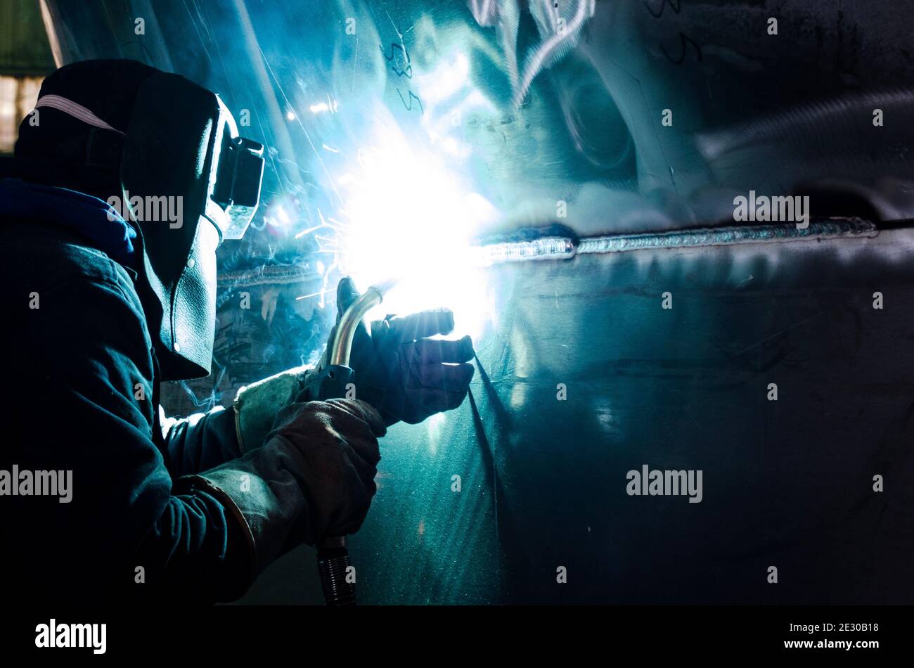 Aluminium Welder doing a perfect weld on ship unit construction Stock Photo