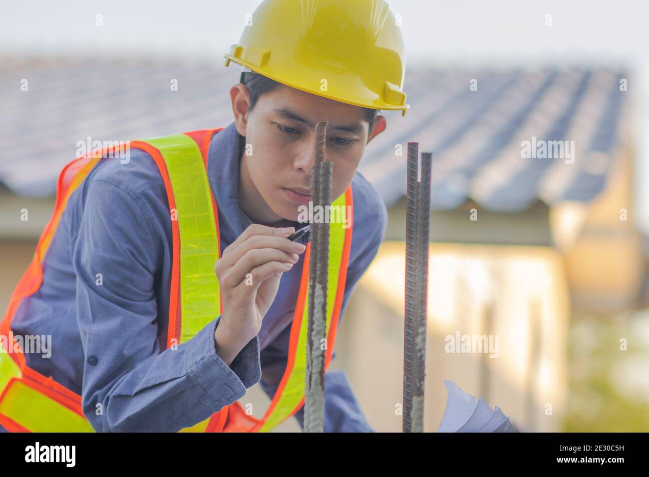 Engineer inspection on site building construction with blueprint Stock