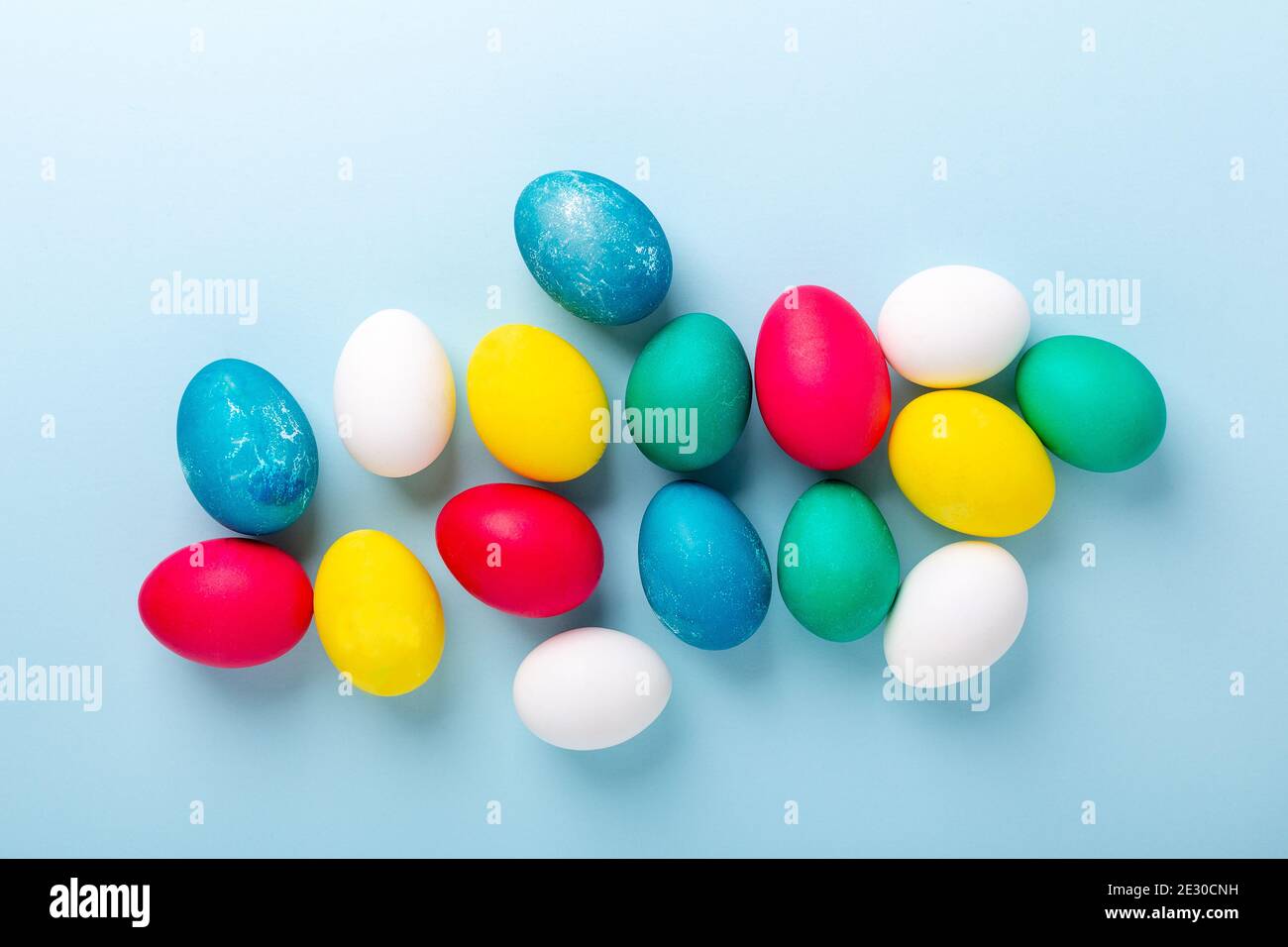 Easter composition. Multicolored easter eggs on blue background. Copy space - Image Stock Photo