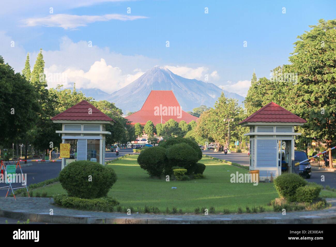 Yogyakarta, Indonesia - March 1, 2020: Gadjah Mada University front gate with Merapi mountain in the background. Stock Photo