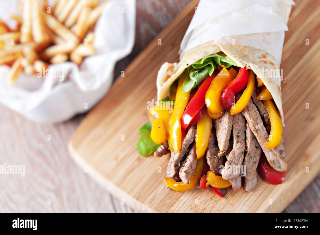 Mexican fajita, wrap made of tortilla, beef, fresh vegetables Stock