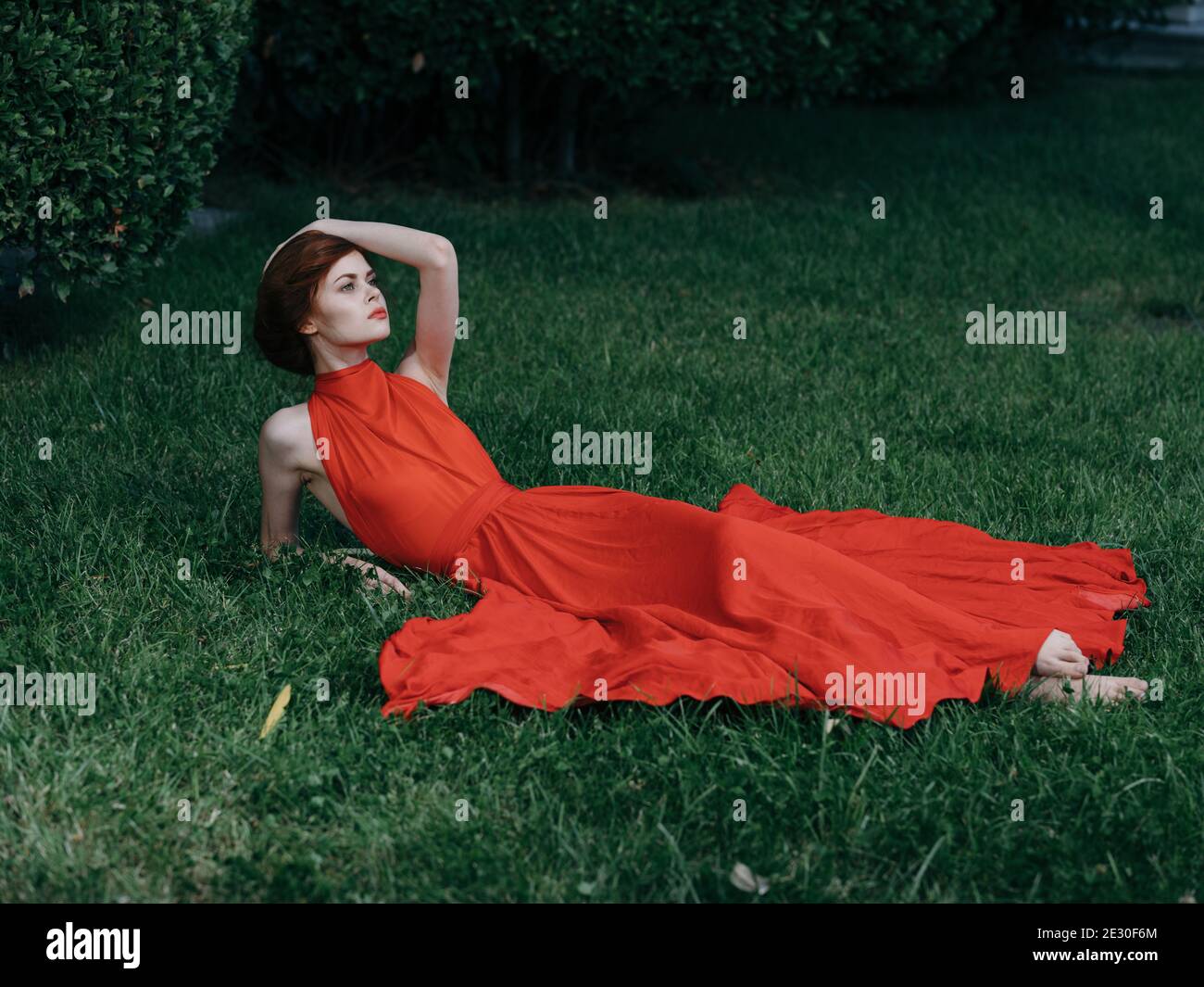 Brunette in red dress lies hi-res stock photography and images - Alamy