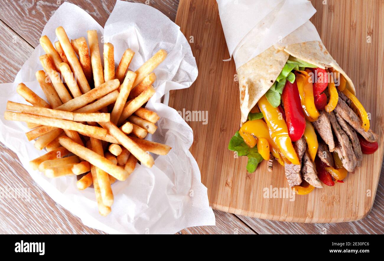 Mexican fajita, wrap made of tortilla, beef, fresh vegetables Stock