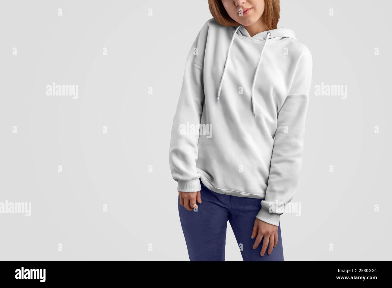 Mockup clothes series. Pretty gracile woman in a white hoodie and blue ...
