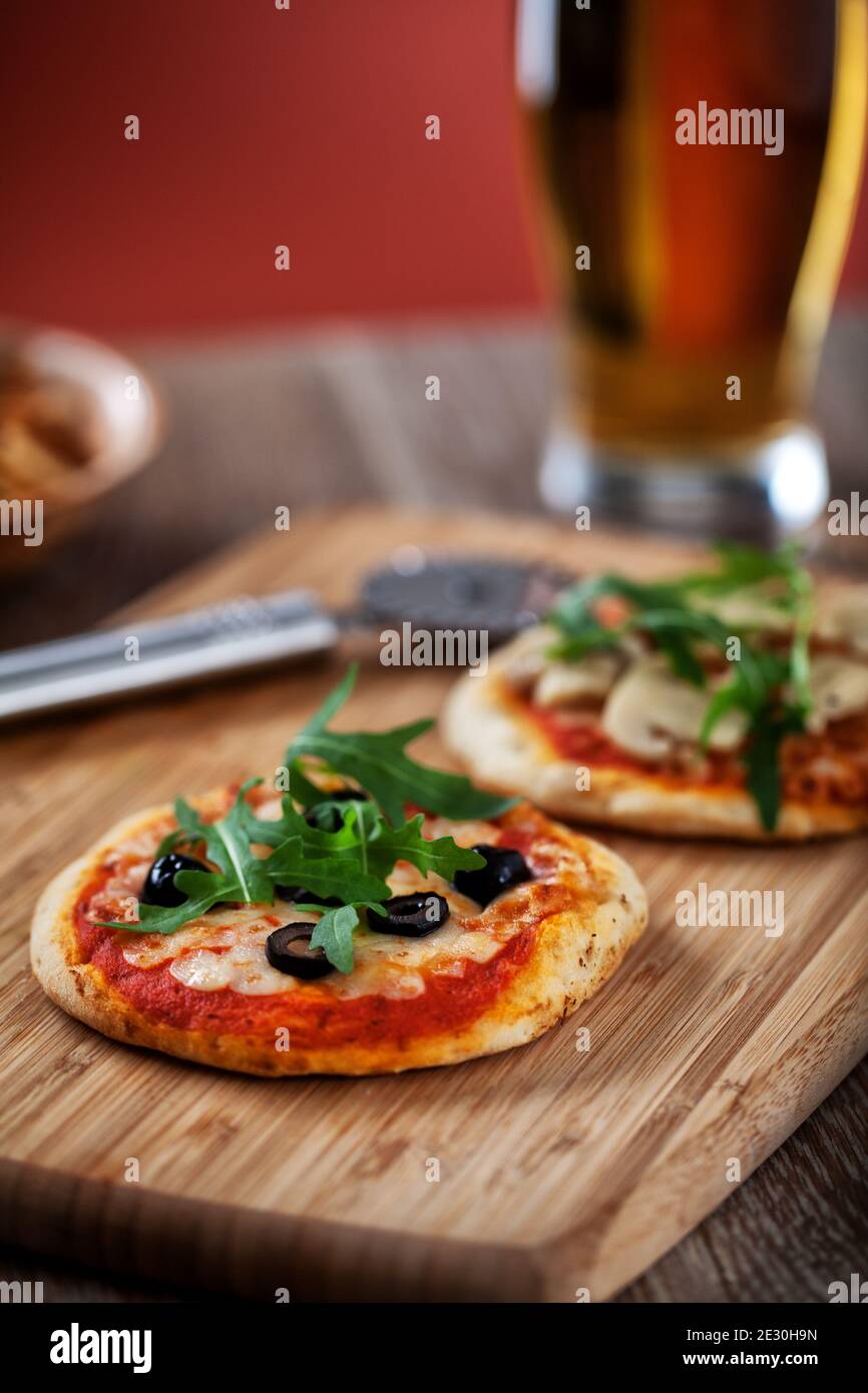 Mini Pizzas served on Wooden Board. High quality photo. Stock Photo