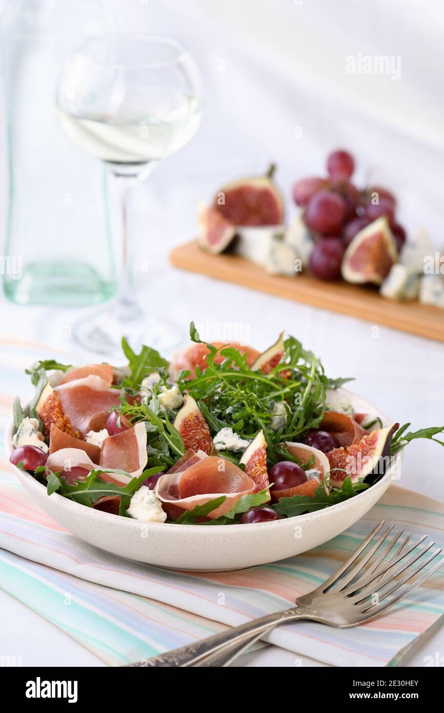 Arugula salad with Parma ham, blue cheese, figs, grapes Stock Photo Alamy