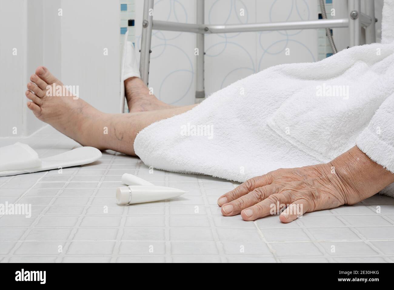 Elderly woman falling in bathroom because slippery surfaces Stock Photo
