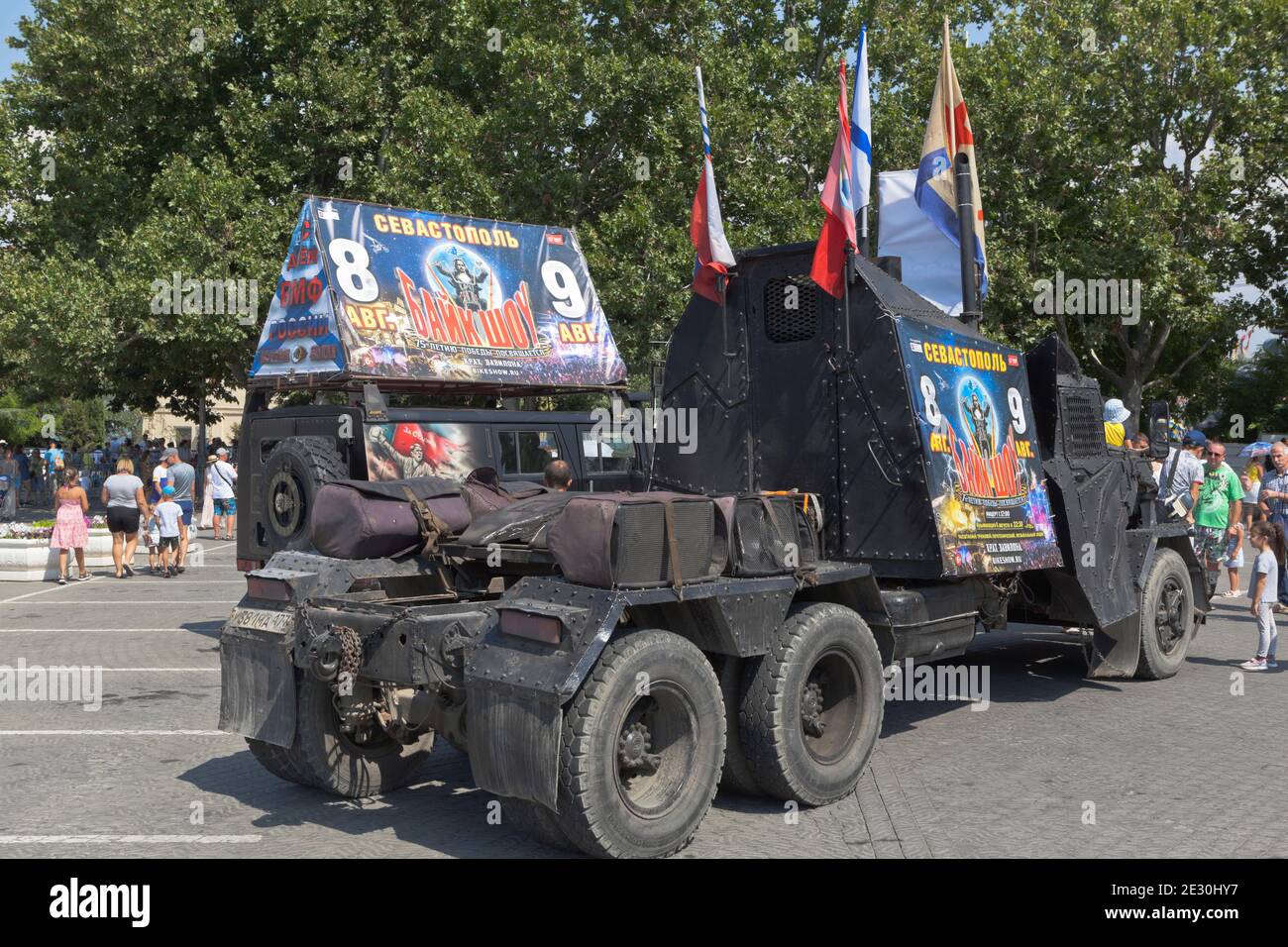 Sevastopol, Crimea, Russia - July 26, 2020: Cars of the bike club Night Wolves with advertising for the show Collapse of Babylon on Nakhimov Square in Stock Photo