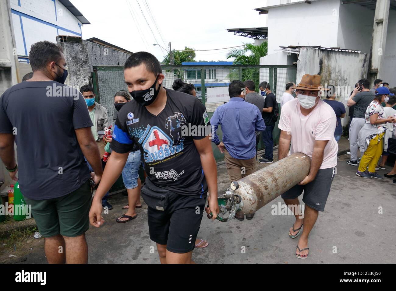 Manaus, Brazil. 15th Jan, 2021. Two people carry the oxygen cylinder at ...