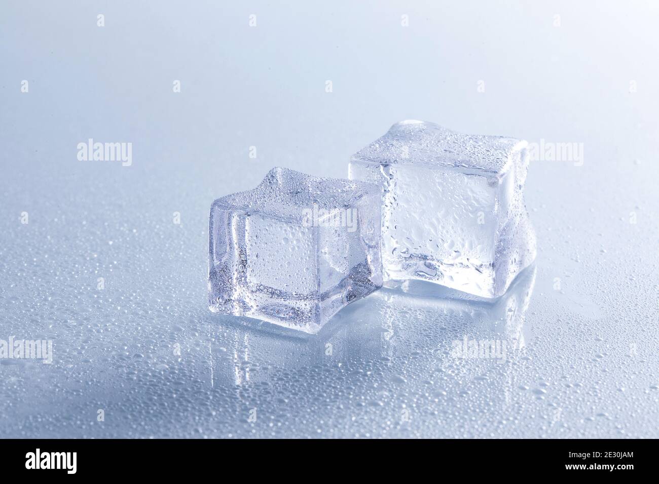 Selective focus shot of melting ice cubes on a wet surface Stock Photo ...