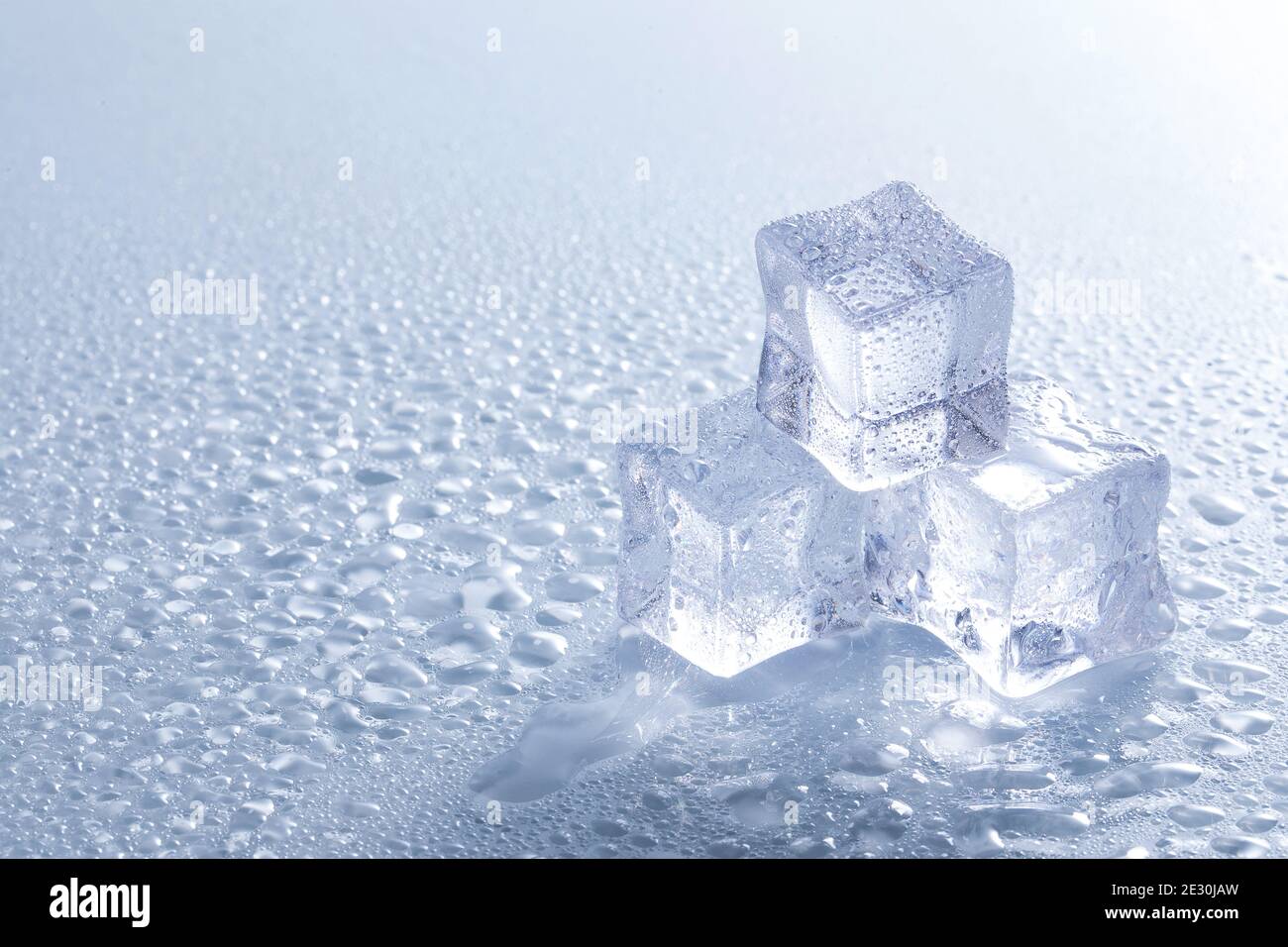 Selective focus shot of melting ice cubes on a wet surface Stock Photo ...