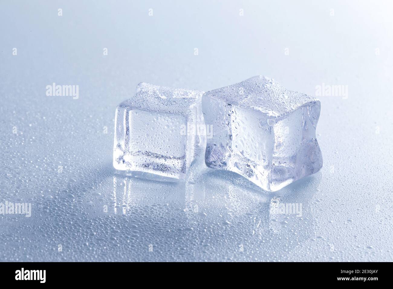 Selective focus shot of melting ice cubes on a wet surface Stock Photo ...