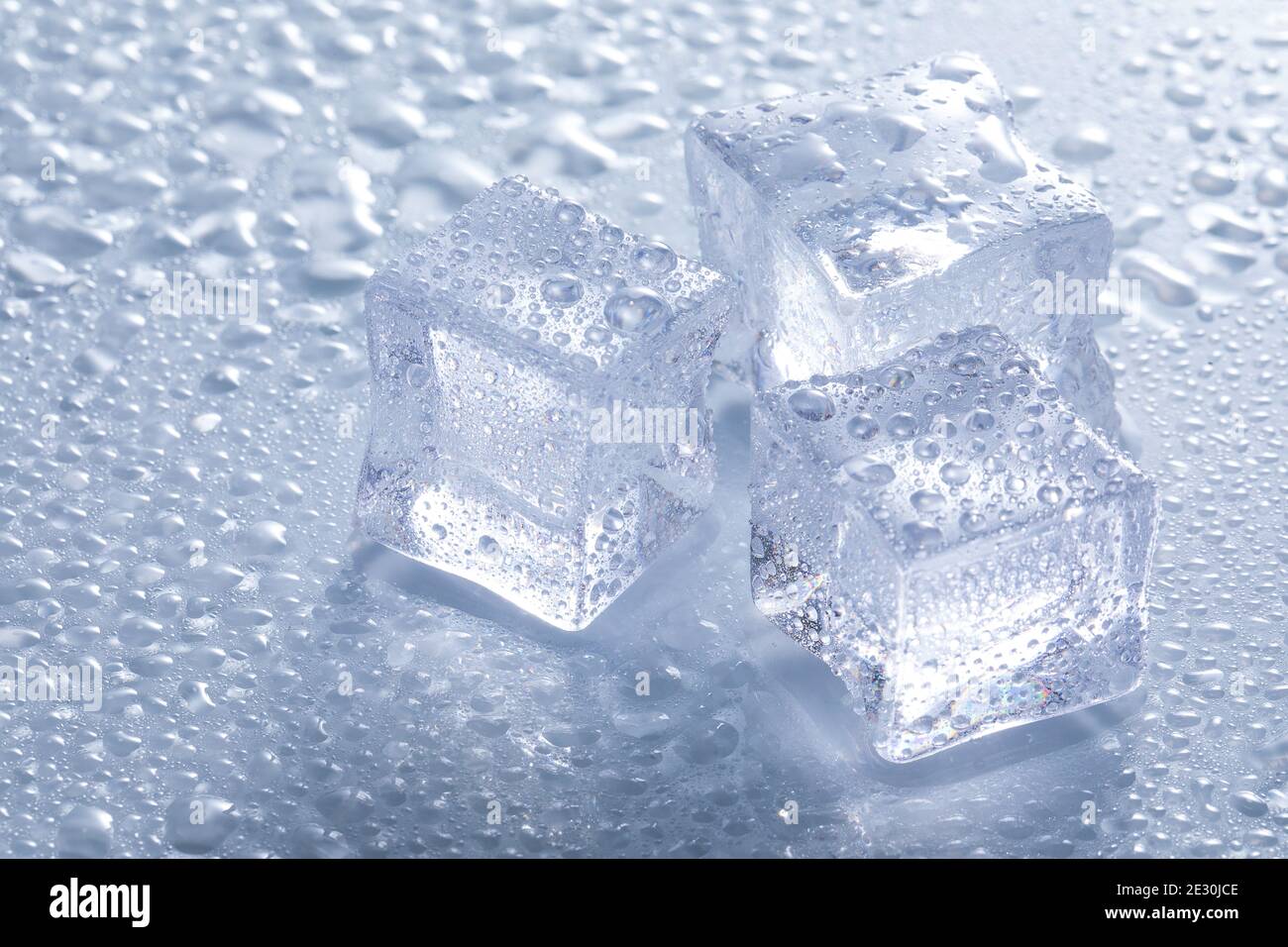 Selective focus shot of melting ice cubes on a wet surface Stock Photo ...