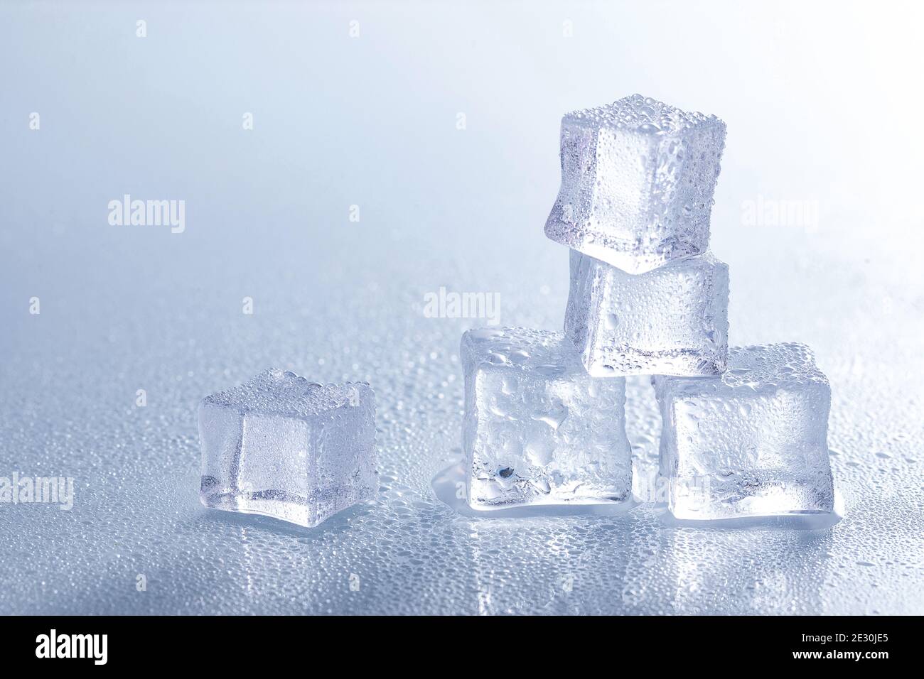 Selective focus shot of melting ice cubes on a wet surface Stock Photo ...