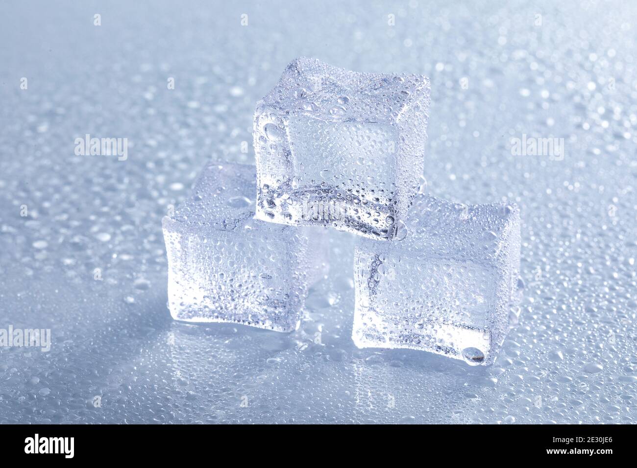 Selective focus shot of melting ice cubes on a wet surface Stock Photo ...