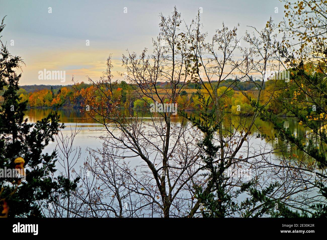 Closeup shot of a lake reflecting the autumn colors of surrounding ...