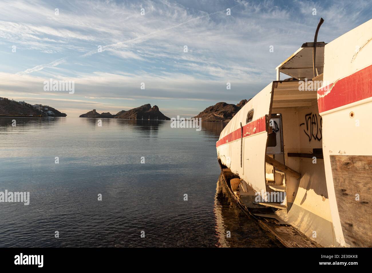 Looking across a shipwrecked sailboat on the beach out onto the bay of San Carlos, Sonora, Mexico. Stock Photo