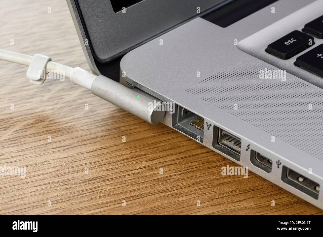 The Magsafe magnetically attached power connector on a 2011 Apple MacBookPro laptop Stock Photo