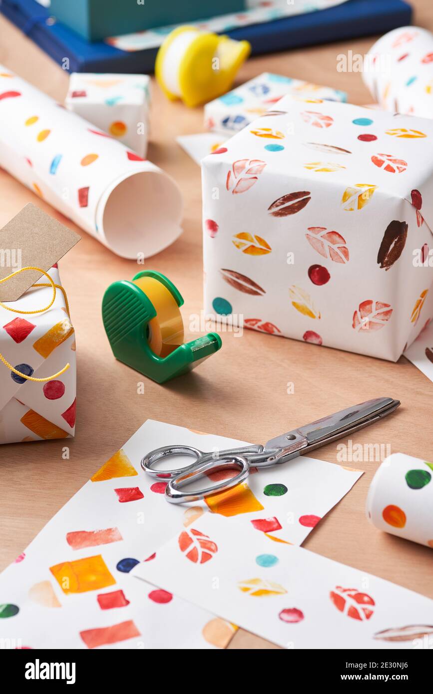 https://c8.alamy.com/comp/2E30NJ6/metal-scissors-and-sticky-tape-placed-near-handmade-ornamental-wrapping-paper-and-gift-boxes-on-table-at-home-2E30NJ6.jpg