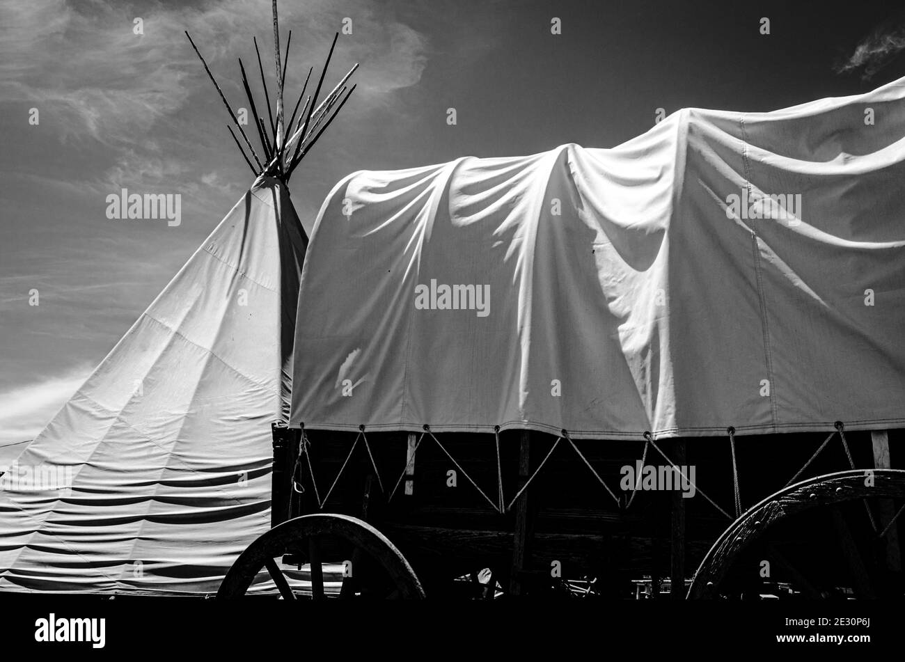 Native American tipi and western chuck covered wagon in Black and white signifies peace,harmony,treaty Stock Photo