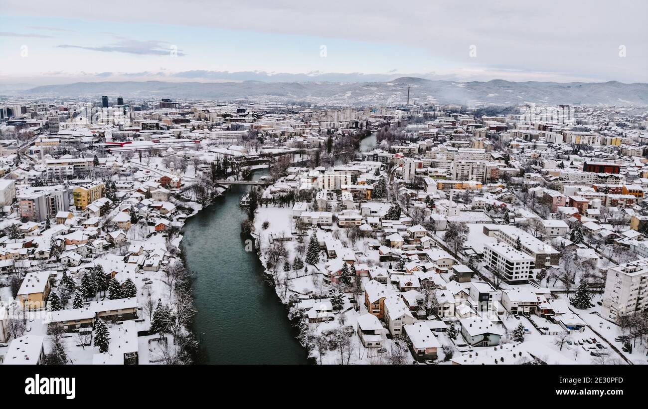 Aerial shot of a river winding through an urban city typical ...