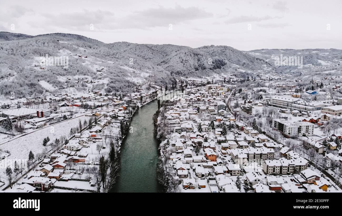 Aerial shot of a river winding through an urban city typical ...
