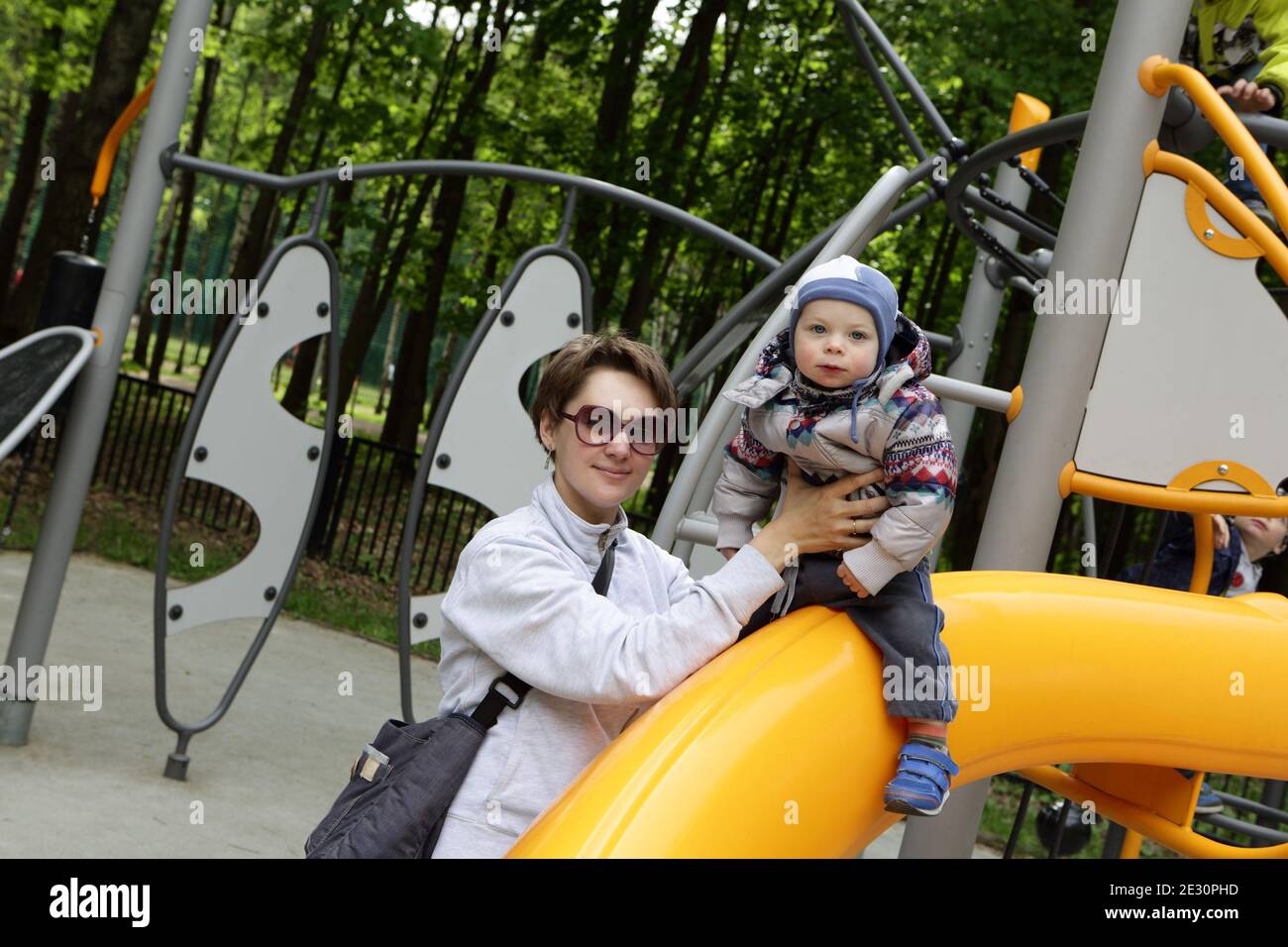 Mother with her son playing at playground Stock Photo - Alamy