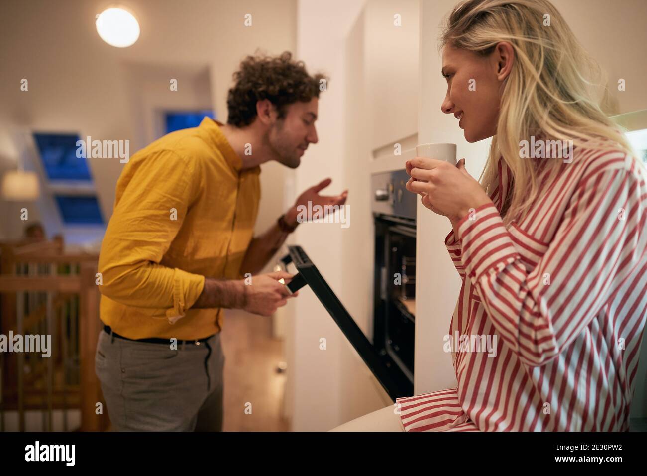Couple baking at home together in the kitchen Stock Photo
