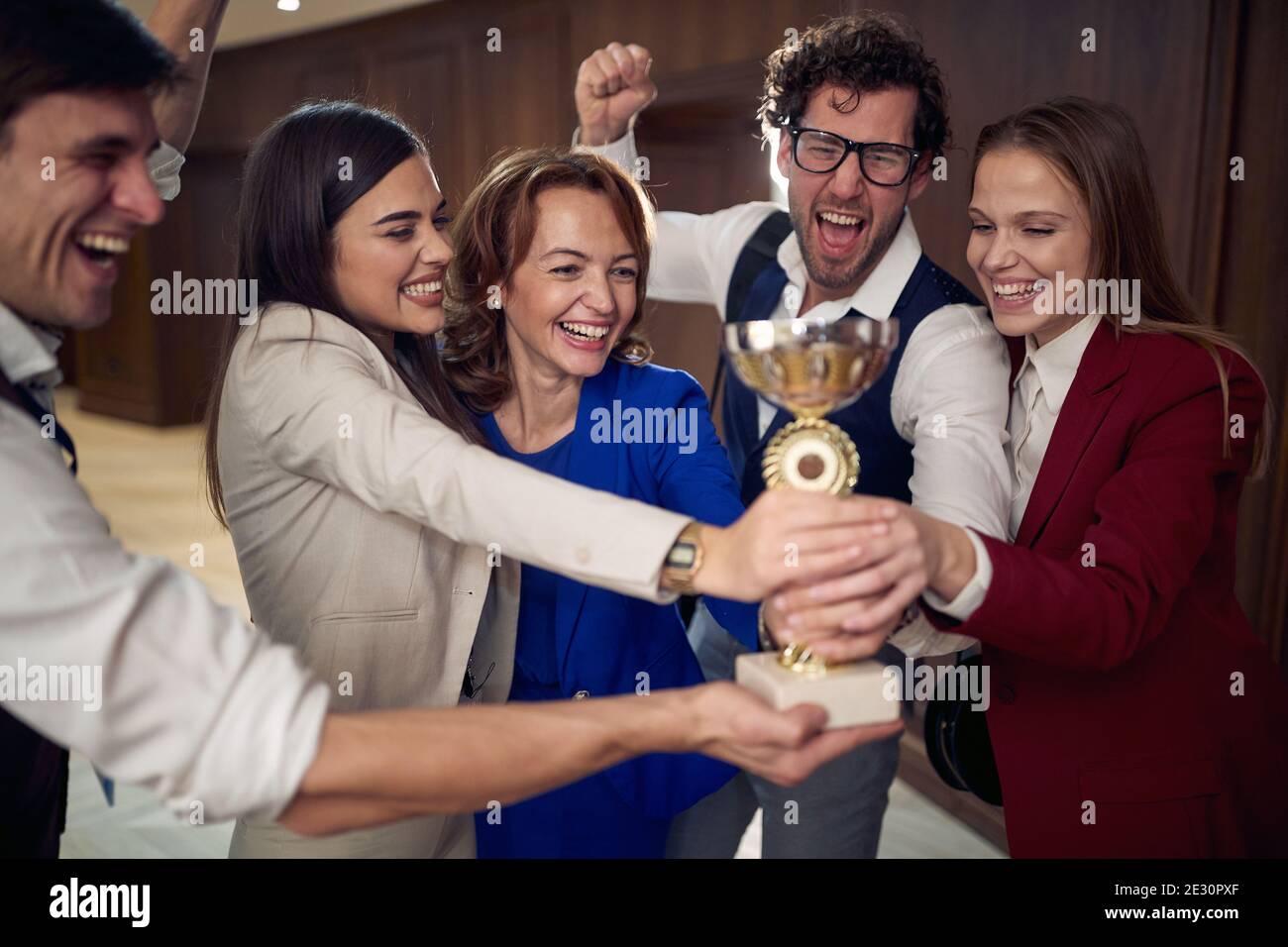 Cheerful manager and a team excited about the award at business conference at the hotel. Hotel, business, people Stock Photo