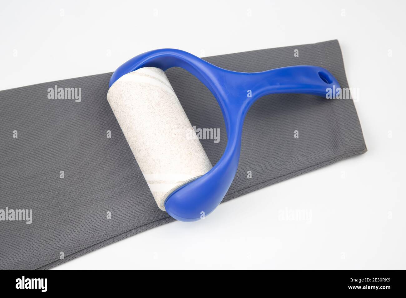 sticky plastic roller for cleaning clothes from dust, lint and hair Stock Photo Alamy