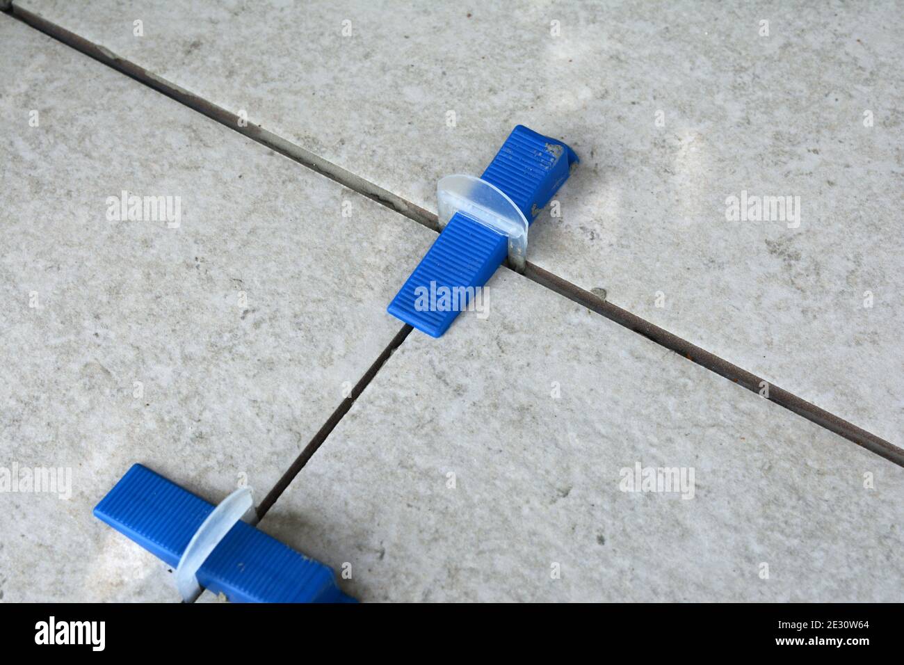 Tile levelling system with plastic clips, wedges and equipment. Stock Photo