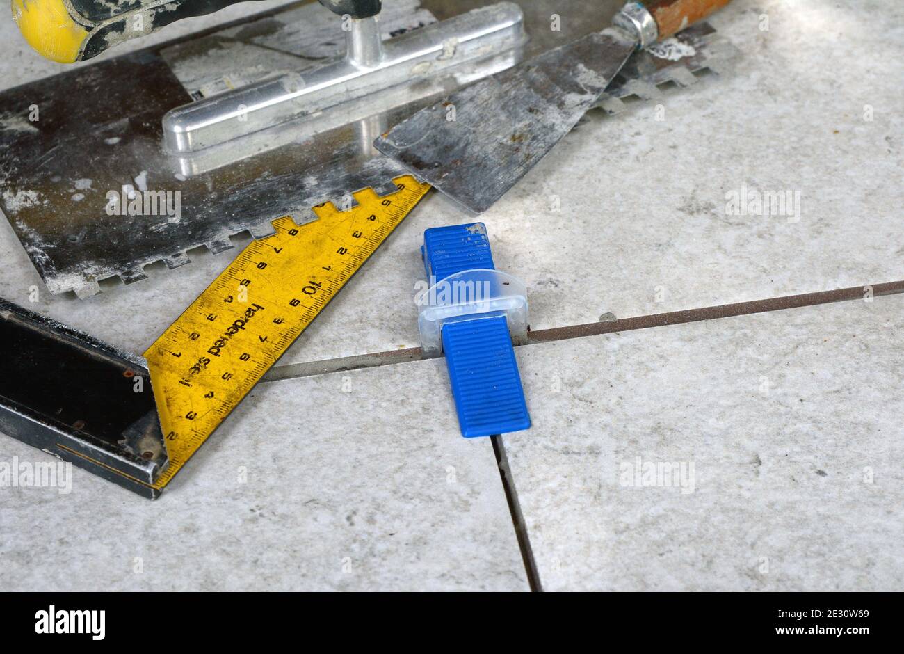 Tile levelling system with plastic clips, wedges and equipment. Stock Photo