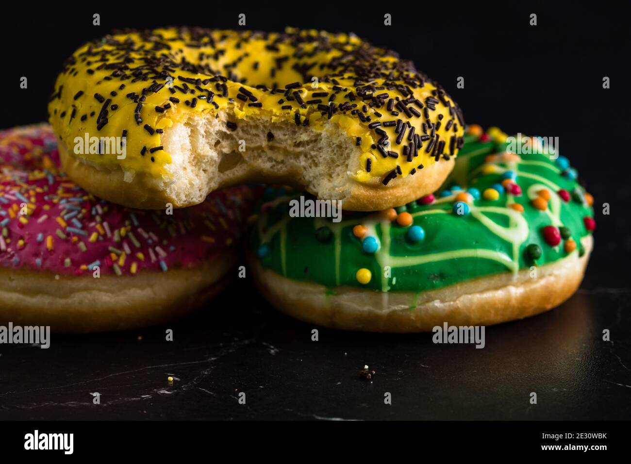 Glazed donuts with sprinkles isolated. Close up of colorful donuts ...