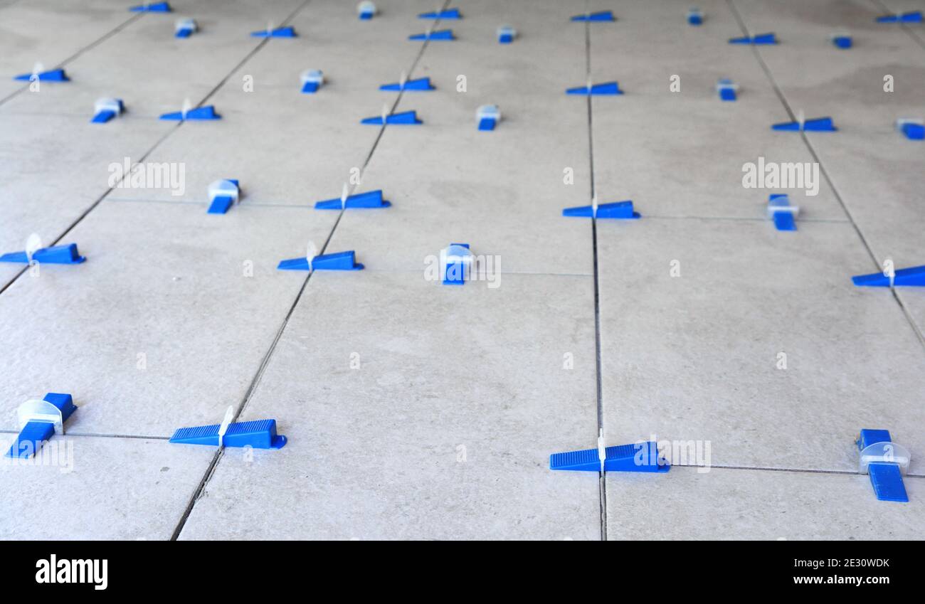 Tile leveling system with plastic clips and wedges, shot while the tile mortar sets Stock Photo