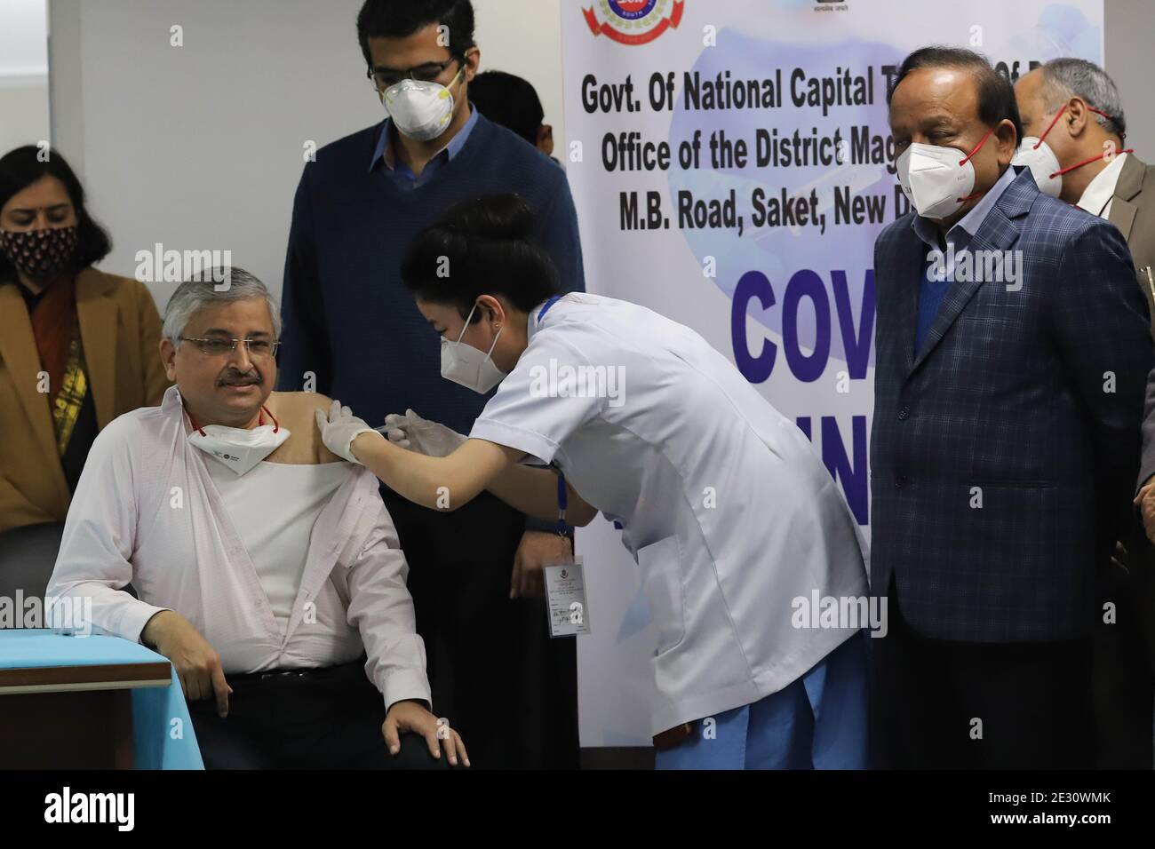 All India Institute of Medical Sciences (AIIMS)  Director Dr. Randeep Guleria gets a jab against Corona Virus as number three to be inoculated in New Delhi on Saturday January 16, 2021. Health Minister Dr. Harshvardhan looks on.  Photograph: Sondeep Shankar Stock Photo