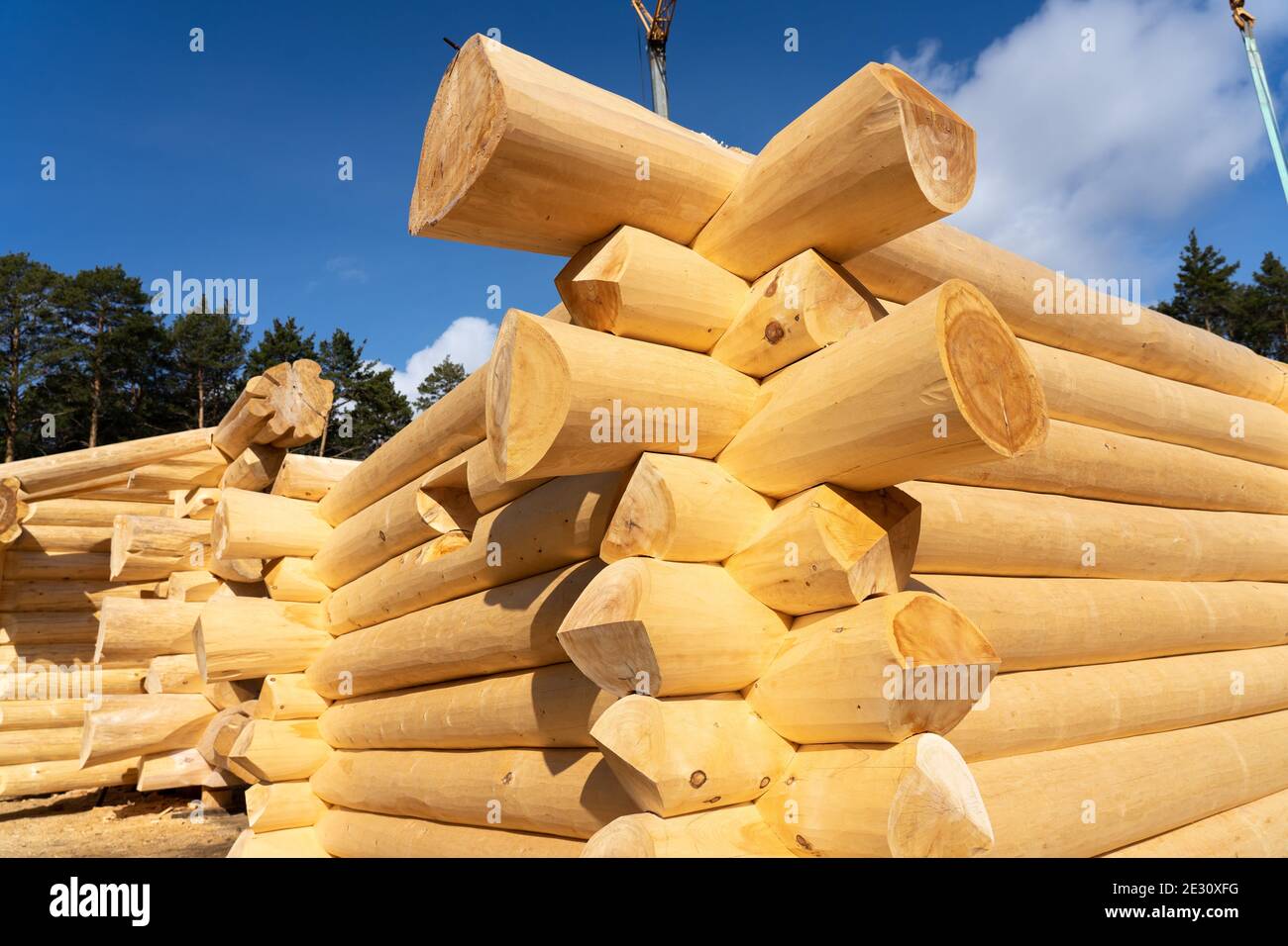 Assembly of a Wooden Log House at a Construction Base Stock Photo - Alamy