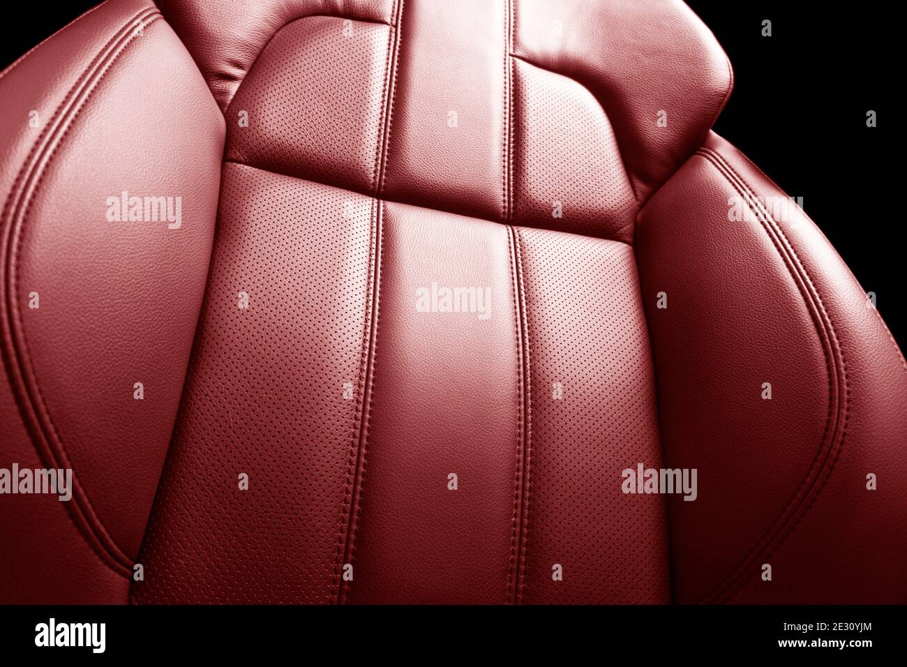 Modern luxury car red leather interior. Part of red leather car seat