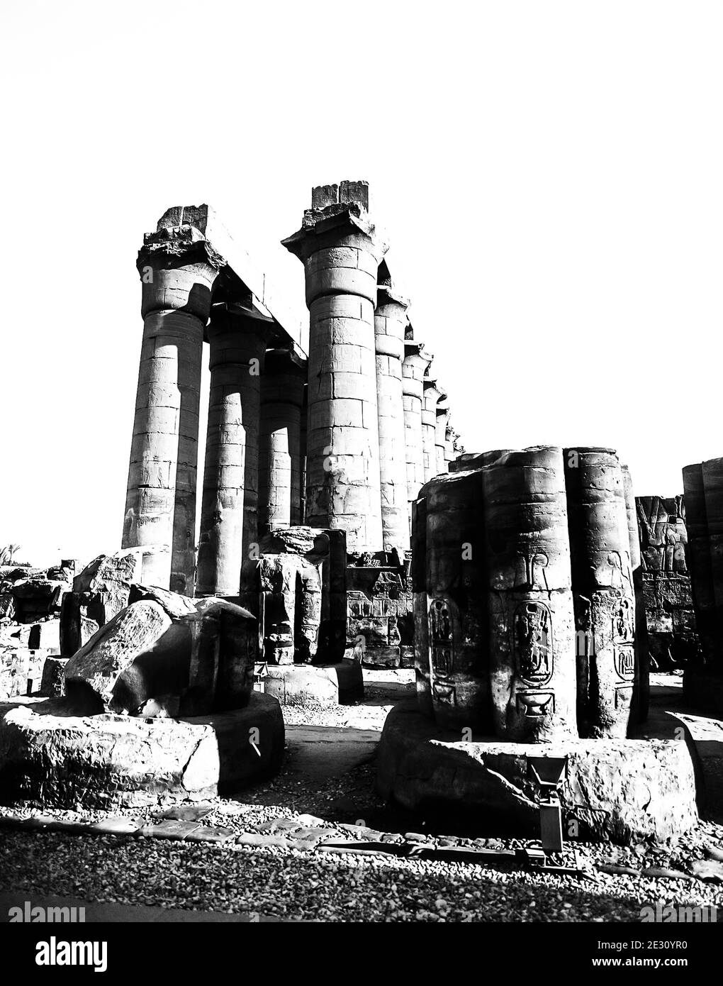 Luxor. These are some of the massive stone columns in what was once the Ramasseum Hypostyle Great Hall at the 3500 year old UNESCO World Heritage site of the Temple of Luxor, part of the largest temple complex in the world,  located on the River Nile at the city of Luxor previously known in the ancient world as Thebes, construction of which is largely credited to Ramesses II, Ramesses the Great. Stock Photo