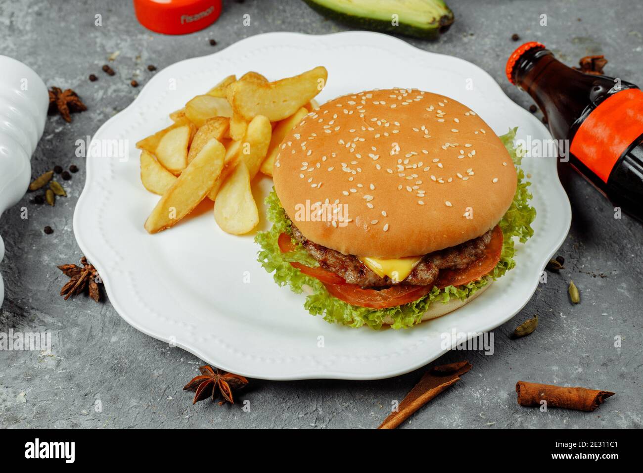 hamburger with fries and salad on the plate Stock Photo