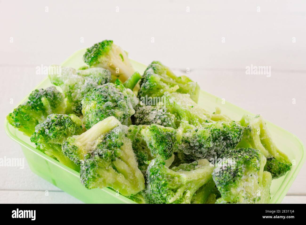 frozen broccoli vegetables in plastic storage containers. Stocks of
