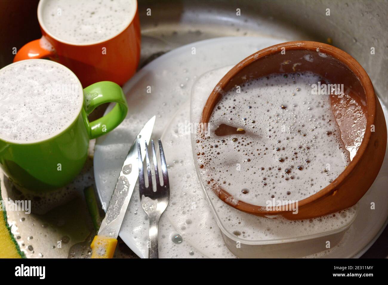 Dish washing. soaking in the kitchen sink. After the Dinner it's time